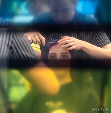 woman having her done in the hairdressers but obscured by the shop window