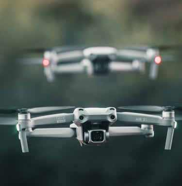 two macic air 2s drones in flight