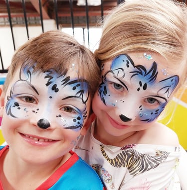 high resolution photo of two smiling children's faces painted by Face Painting by Ana