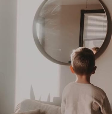 child looking into a round mirror recommending email subscription for nutrition and wellness help