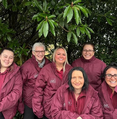 Image of the AMG Nursing & Care services team outside in their branded jackets