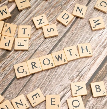 scrabble pieces spelling the word growth