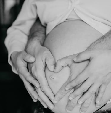 Mains en cœur sur ventre rond – photo de grossesse à domicile dans le Gard