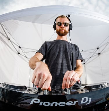 a man in a black shirt and headphones on a dj - set