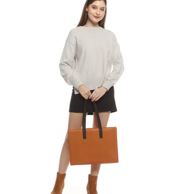 a woman in brown boots and brown totebag