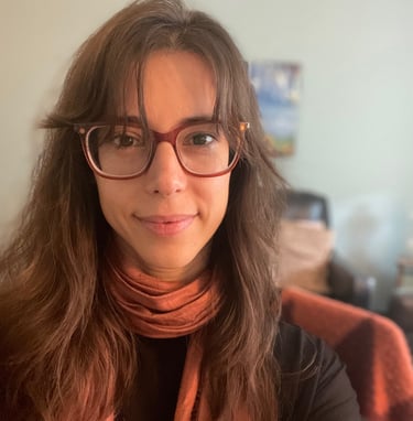 a woman with glasses and a scarf around her neck