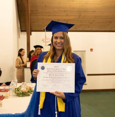 a woman in a graduation gown holding a diploma certificate