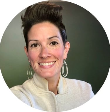 a woman with a short haircut and earrings