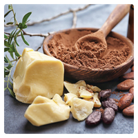 Raw organic cocoa butter chunks with cacao powder and beans for natural skincare and baking.