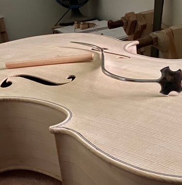 cello in the white with a soundpost and a sound post setter