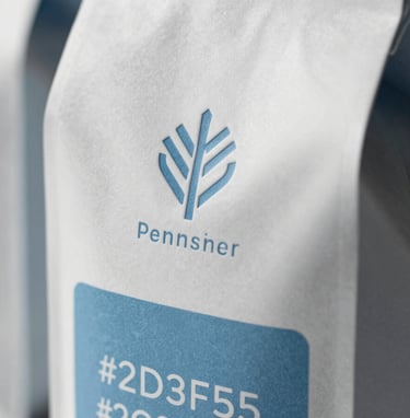 Close-up of premium sustainable packaging design with embossed logos and tactile textures. The lighting is dramatic, highlighting the structural integrity and quality of the materials. Incorporates #8D9FB5 and #2C3E50 tones. Modern and sophisticated.