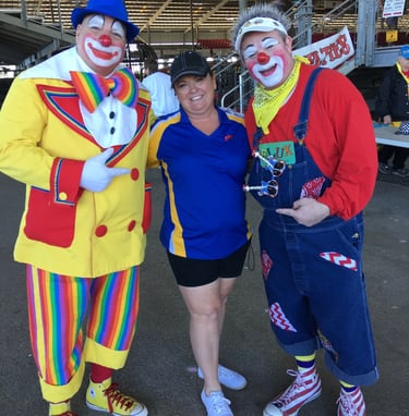 Deanna the Inspector standing next to 2 clowns