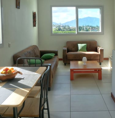 a living room with a table and chairs