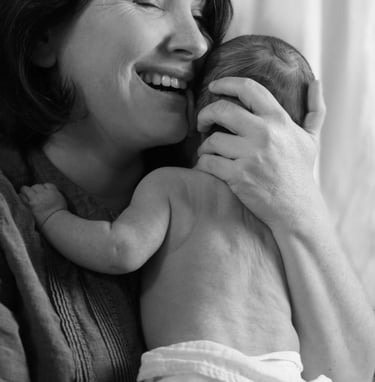 a woman holding a baby in her arms