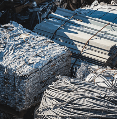 a pile of metal wire and aluminum sheets