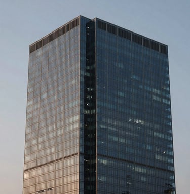 An architectural detail of a contemporary South American / Brazilian skyscraper against a twilight sky, showcasing glass and steel in muted steel blue and pale grayish blue hues.