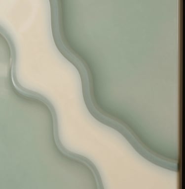 A close-up photograph of a finished resin panel with intricate pristine cream and muted sage green textures, emphasizing the smooth, glossy finish.