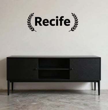 Minimalist interior of a building in Recife, featuring a deep matte black furniture piece against a soft off-white wall. High-quality editorial photography style.