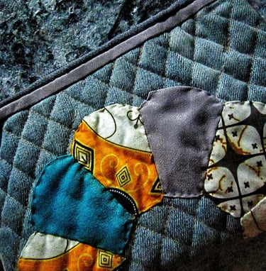 Recycled fabric pouch with colorful applique fro beautiful pouch