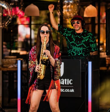 DJ and Sax, saxophonist dj combo in action at outdoor wedding.
