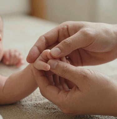A close-up of a family's hands intertwined, showing a newborn's tiny fingers. Soft cocoa and warm sand color palette. Natural, intimate lighting in a light and airy North American / US (West Michigan) home setting.