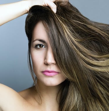 a woman with long hair and a pink lipstick