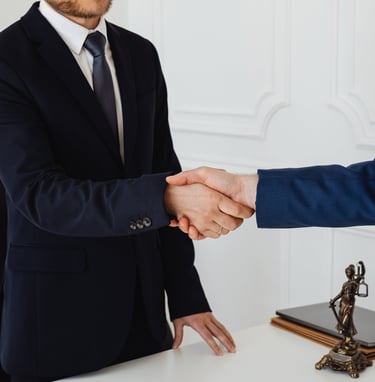 a man in a suit and tie is shaking hands