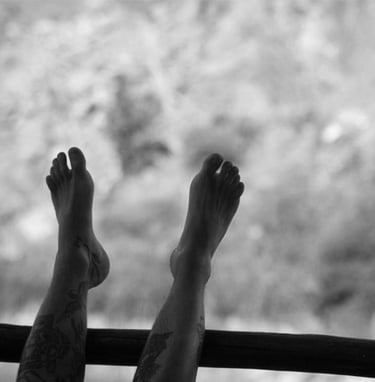 Pies en alto sobre el vidrio de una ventana