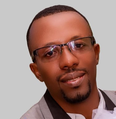 a man in a suit and glasses with a white shirt