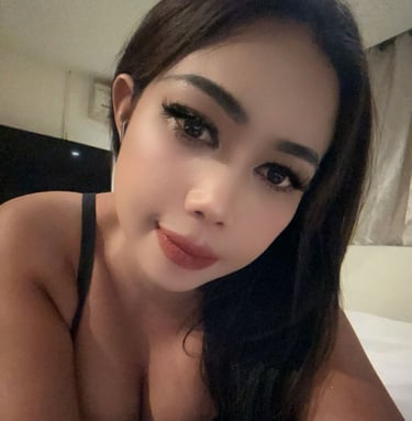 Lady lying on bed taking a close up selfie