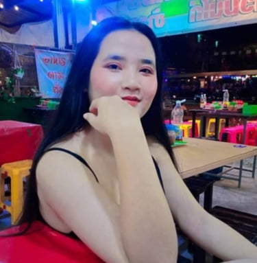 lady sat on chair with arm leaning on table and hand on chin