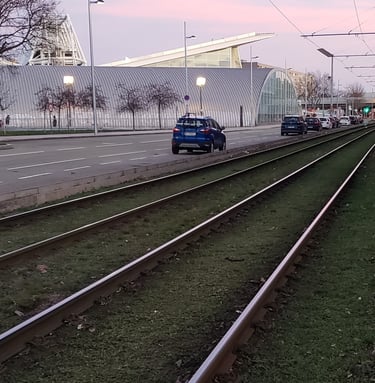 Light rail train tracks next to a road