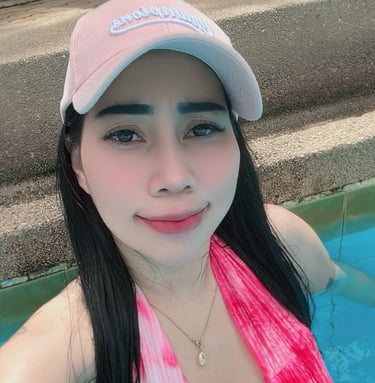 lady in a swimming pool wearing pink bikini and baseball cap