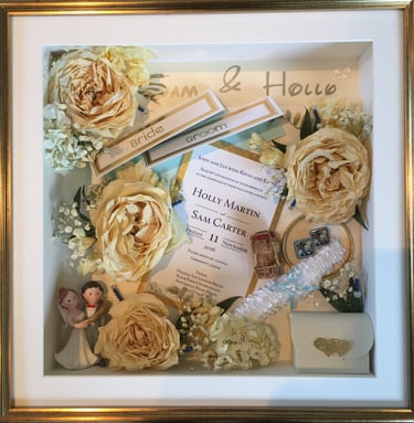 a Memory Box frame featuring wedding keepsakes and flowers