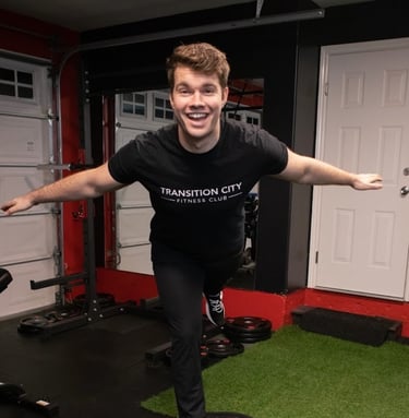 dustin king on a bozu ball smiling and doing a plane pose