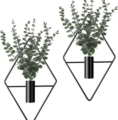 Two black geometric diamond-shaped wall planters featuring artificial eucalyptus leaves for modern home decor.