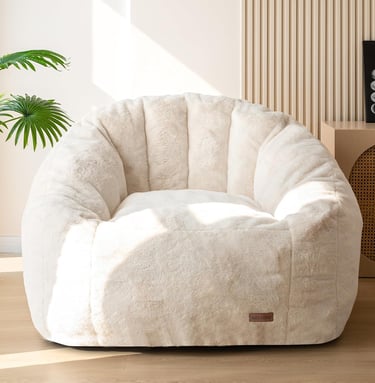 Oversized faux fur cozy reading chair in a neutral beige living room