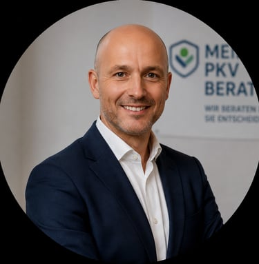 Professional portrait of a male private health insurance advisor in a navy suit and white shirt.