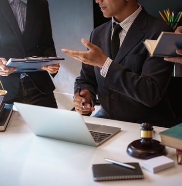 a man in a suit and tie is holding a tablet computer