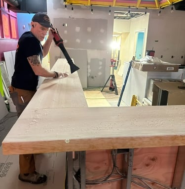 a man is using a sandblaker to make a counter top