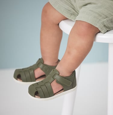 Fashion campaign photography - a baby's feet wearing green sandals