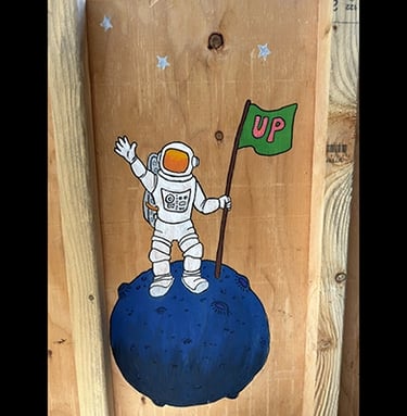 Shipping crate for Talbotics sculpture with image of astronaut drawn on it.