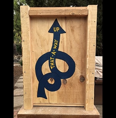 Shipping crate for Talbotics sculpture with image of squiggly arrow drawn on it.
