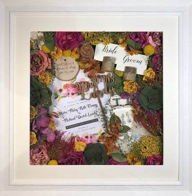 memory box full of preserved wedding flowers, place names, save the date, cork and cufflinks