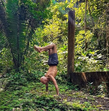 devon bennett holding a handstand in nature