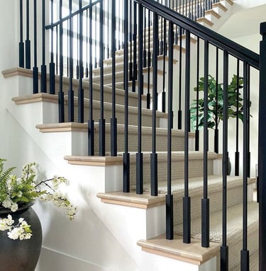 Modern matte black aluminum staircase railing for luxury villa interior.