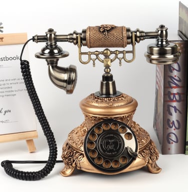 Vintage antique style rotary dial telephone with ornate copper floral carvings and classic handset.