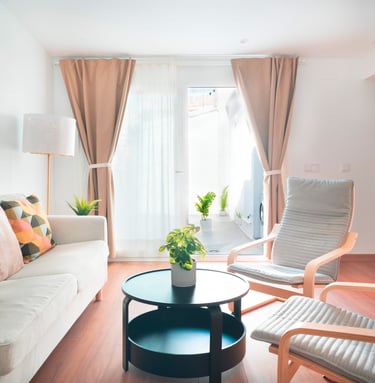 a living room with a couch and chairs