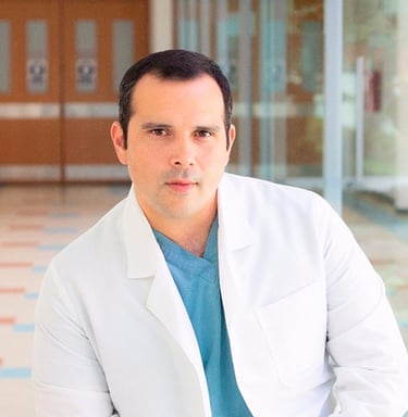 a man in a white lab coat and blue jeans