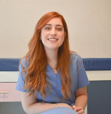 a woman in scrubies sitting on a chair
